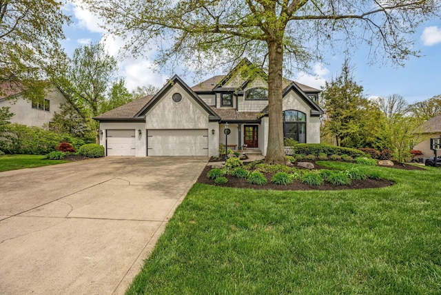 traditional-style home featuring an attached garage, driveway, stucco siding, and a front yard