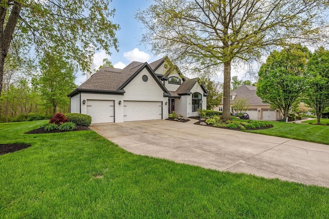 view of front of property featuring an attached garage, driveway, a shingled roof, and a front lawn