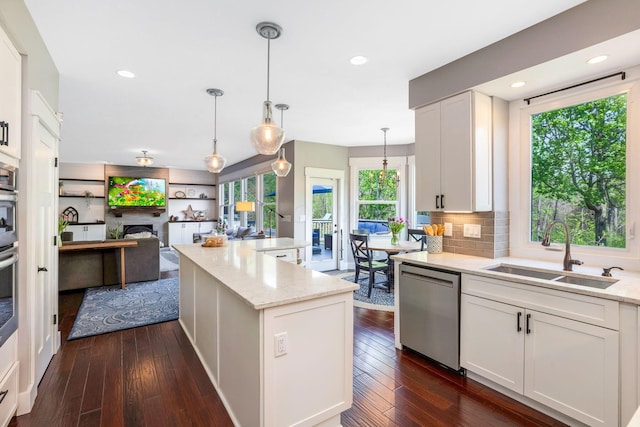kitchen featuring a sink, dark wood-style flooring, white cabinetry, and dishwasher