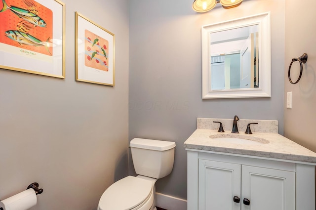bathroom featuring toilet and vanity
