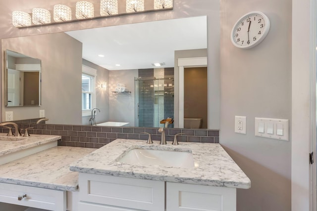 full bathroom featuring vanity, backsplash, and a stall shower