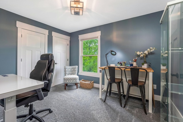 carpeted home office with baseboards
