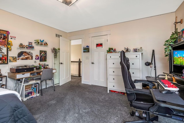 office area featuring visible vents and carpet flooring