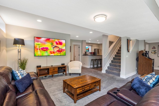 living area featuring carpet flooring, recessed lighting, baseboards, and stairway