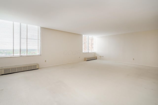 1000 Urlin Ave Unit 1407, Columbus, OH 43212 - carpeted empty room featuring baseboards, a healthy amount of sunlight, and radiator
