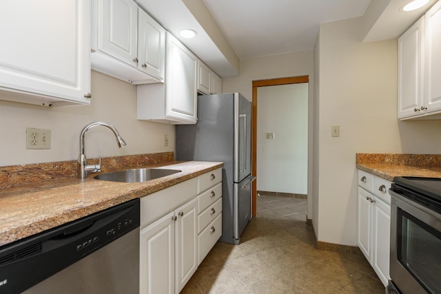 1000 Urlin Ave Unit 1407, Columbus, OH 43212 - kitchen with appliances with stainless steel finishes, a sink, baseboards, white cabinets, and light tile patterned floors