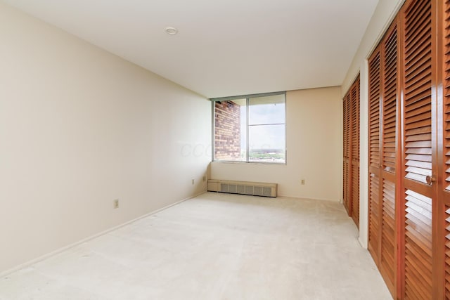 1000 Urlin Ave Unit 1407, Columbus, OH 43212 - unfurnished bedroom featuring light carpet and radiator