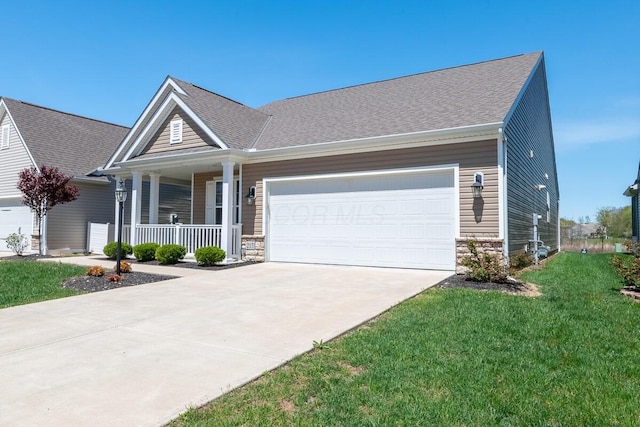 view of front of property with a porch, a garage, stone siding, and concrete driveway