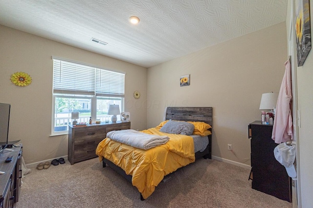 bedroom with baseboards, carpet flooring, and visible vents