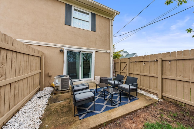rear view of property featuring central AC, stucco siding, outdoor lounge area, a fenced backyard, and a patio