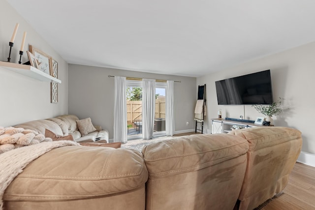 living room featuring baseboards and wood finished floors