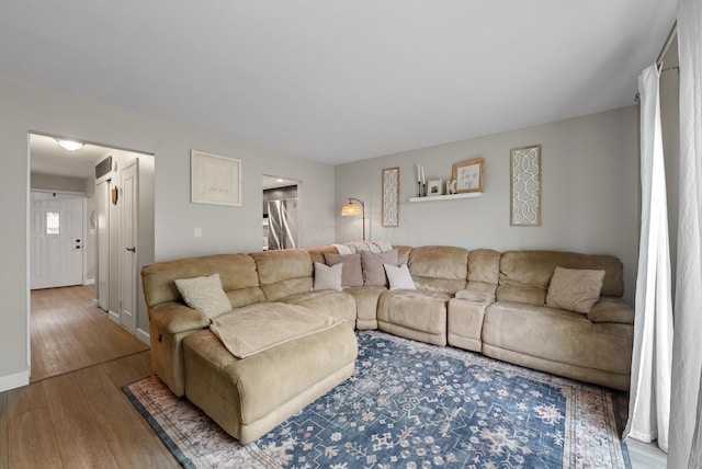 living area featuring baseboards and wood finished floors