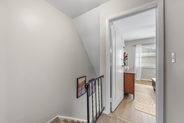 stairway featuring baseboards and wood finished floors