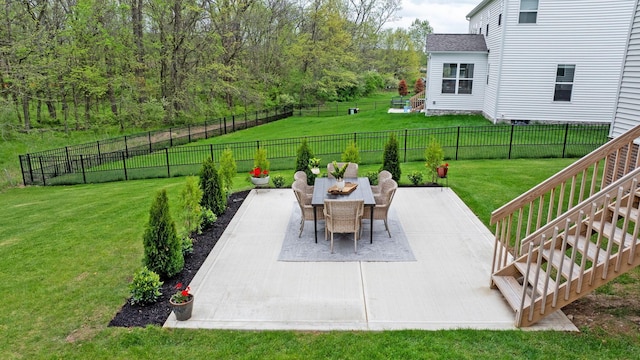 view of patio with stairs, a fenced backyard, and outdoor dining space