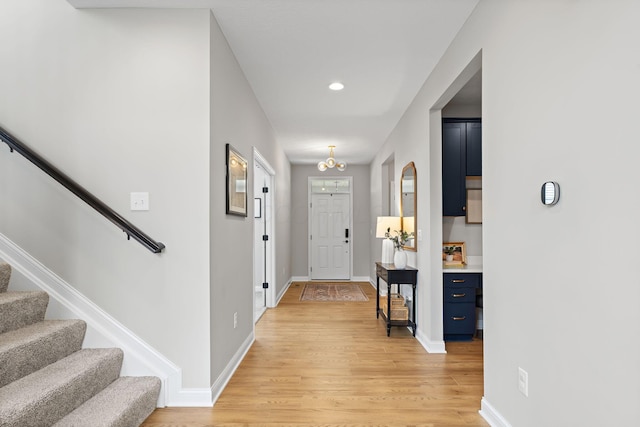 foyer with stairway, baseboards, recessed lighting, and light wood-style flooring