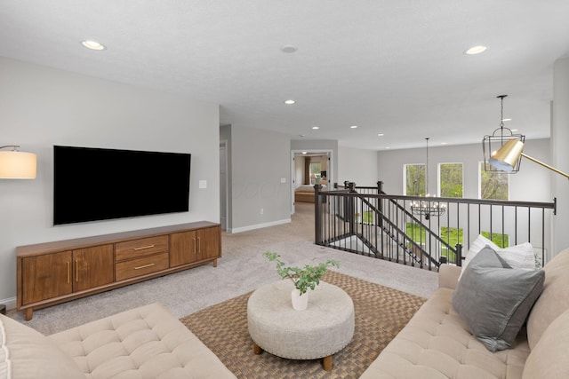 living area with recessed lighting, baseboards, and light carpet