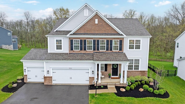 view of front facade with aphalt driveway, fence, a shingled roof, and a front lawn