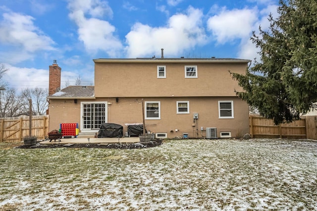 back of house featuring a patio, a fenced backyard, central AC, and stucco siding