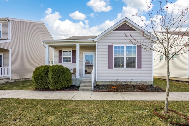 view of front of house featuring covered porch and a front yard