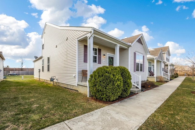 view of property exterior with a lawn and a porch