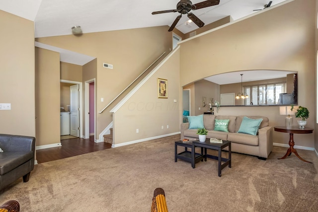 living room with visible vents, stairs, ceiling fan, high vaulted ceiling, and carpet flooring