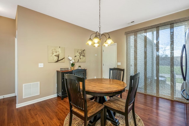 dining area with visible vents, dark wood finished floors, baseboards, and a notable chandelier