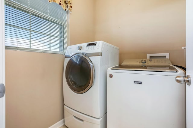 clothes washing area with laundry area and washer and dryer