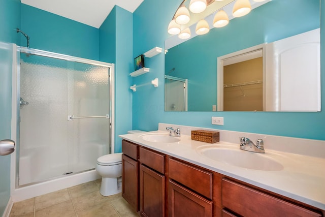 full bathroom featuring double vanity, a sink, tile patterned flooring, and a stall shower