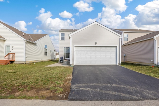 view of front of house featuring a garage, driveway, a front yard, and cooling unit