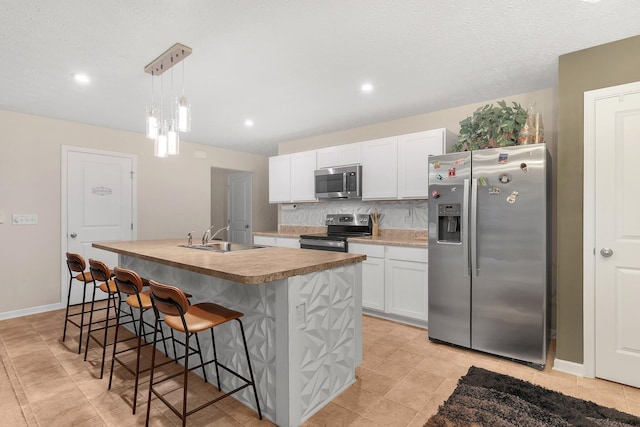 8573 Greengate Blvd Unit 41, Canal Winchester, OH 43110 - kitchen featuring a sink, white cabinets, tasteful backsplash, and stainless steel appliances