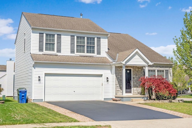 traditional home with a garage, stone siding, a shingled roof, and aphalt driveway