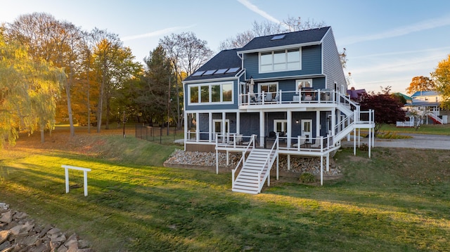 301 John St, Belpre, OH 45714 - rear view of property with a wooden deck, a sunroom, stairs, and a yard