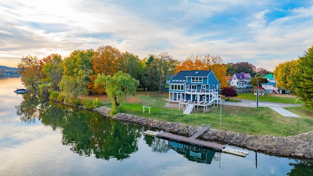 301 John St, Belpre, OH 45714 - rear view of property featuring a yard and a water view