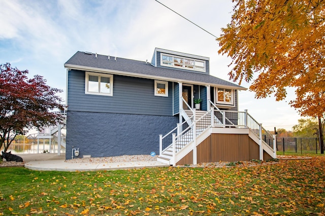 301 John St, Belpre, OH 45714 - view of front of property with a porch, fence, a front yard, and stairway