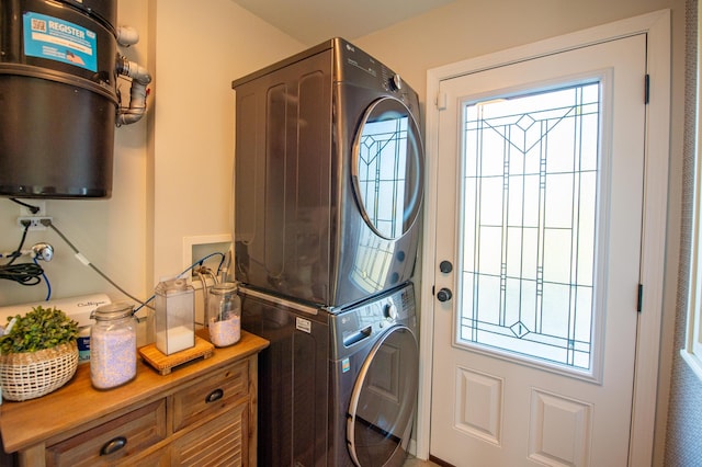 301 John St, Belpre, OH 45714 - clothes washing area featuring laundry area, a healthy amount of sunlight, and stacked washer / dryer