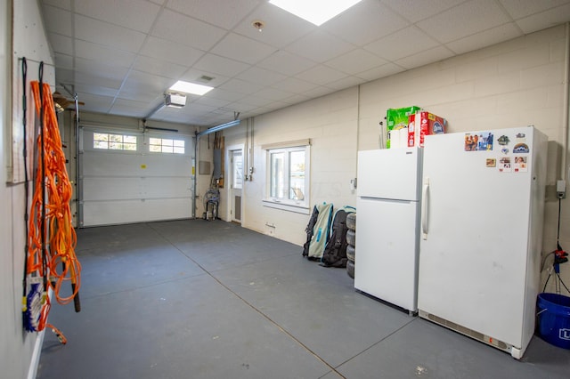 301 John St, Belpre, OH 45714 - garage with freestanding refrigerator and concrete block wall