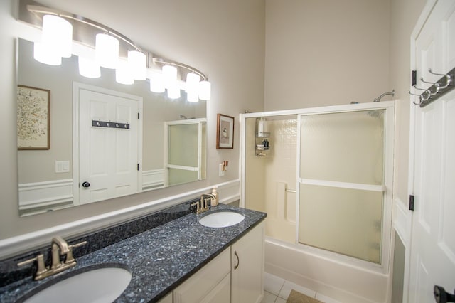 301 John St, Belpre, OH 45714 - full bathroom with double vanity, a sink, tile patterned floors, and bath / shower combo with glass door