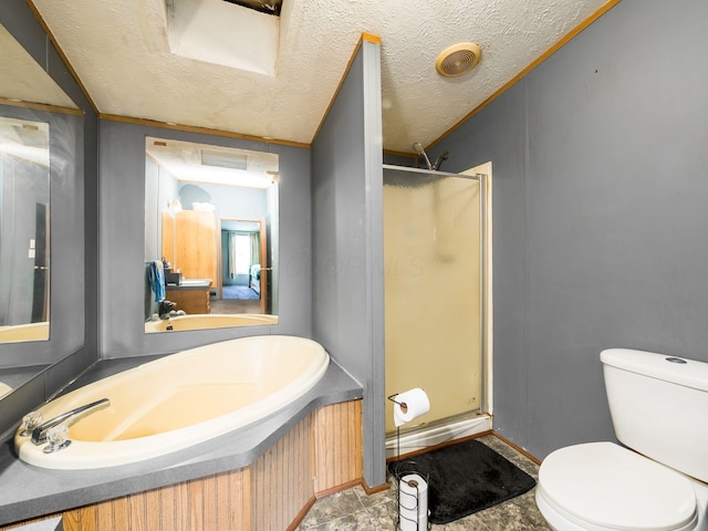 full bath featuring a sink, a textured ceiling, a stall shower, and toilet