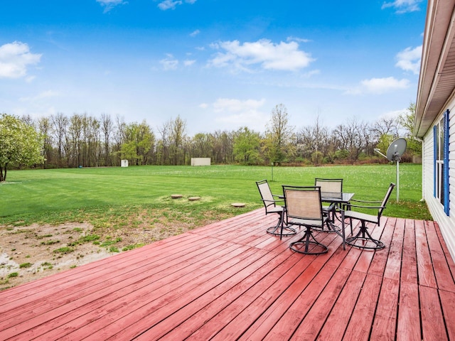 deck featuring a yard and outdoor dining area
