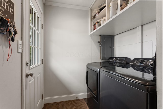 clothes washing area featuring laundry area, ornamental molding, washer and dryer, baseboards, and electric panel
