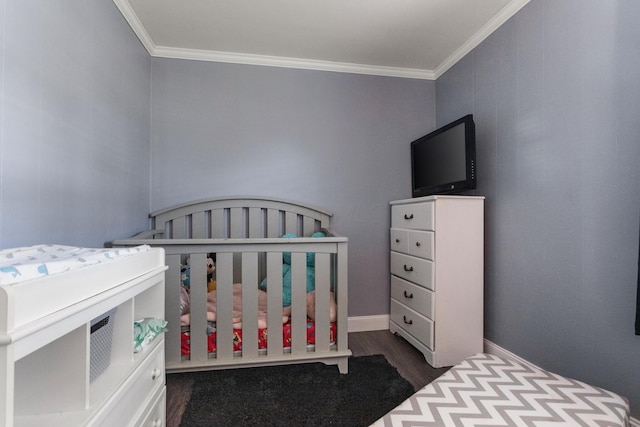 bedroom with crown molding and dark wood finished floors