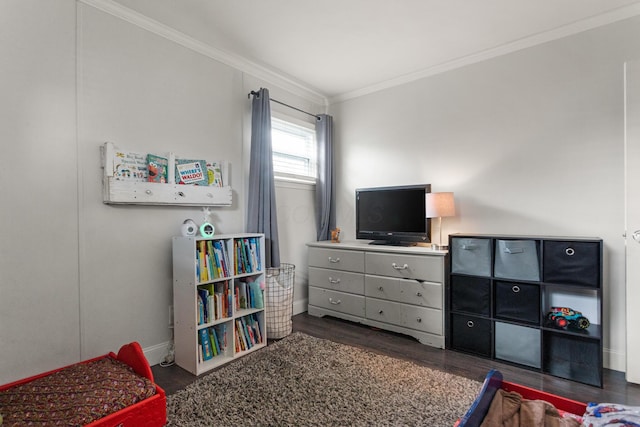 bedroom with crown molding, baseboards, and dark wood-type flooring
