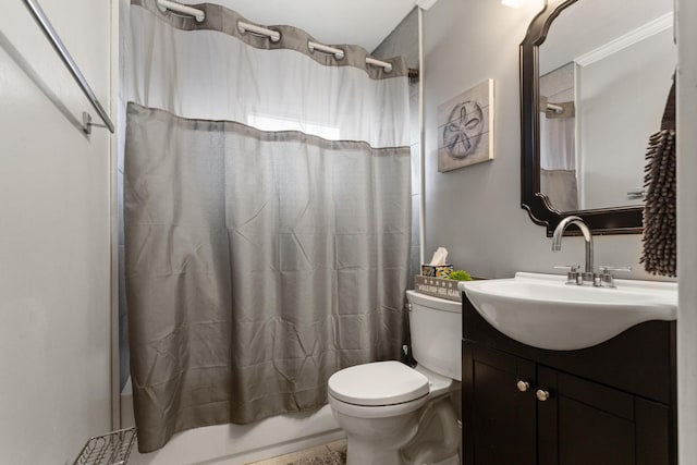 bathroom featuring vanity, toilet, and shower / tub combo