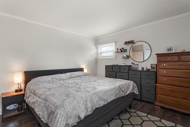 bedroom featuring ornamental molding and dark wood finished floors