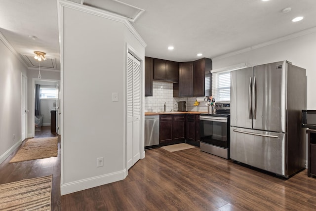 kitchen featuring crown molding, appliances with stainless steel finishes, dark brown cabinetry, and dark wood-style floors