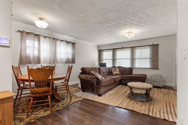 living area with crown molding and wood finished floors