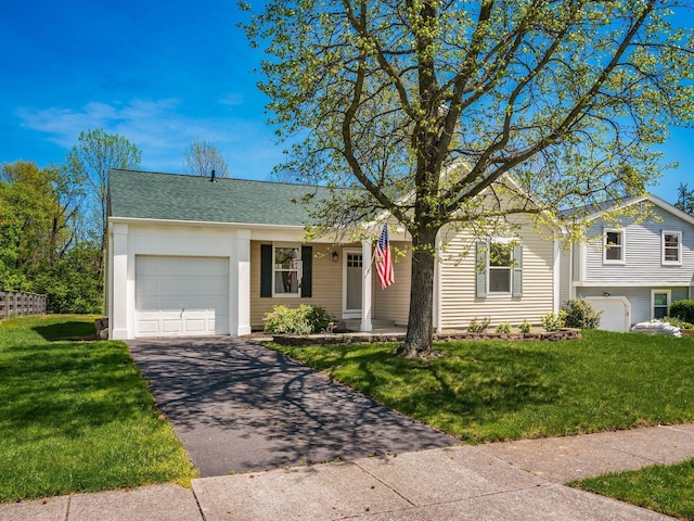 single story home with a garage, a shingled roof, a front yard, and aphalt driveway
