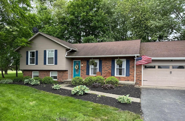 4959 Hughes Rd, Prospect, OH 43342 - split level home with brick siding, a front yard, an attached garage, driveway, and roof with shingles