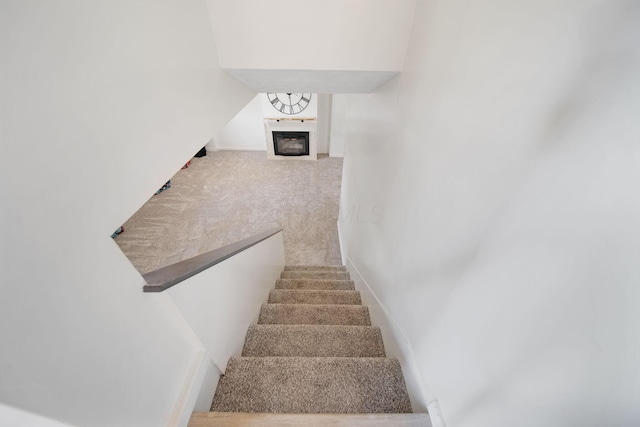 4959 Hughes Rd, Prospect, OH 43342 - stairs featuring a glass covered fireplace, carpet, and baseboards