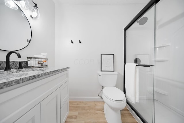 4959 Hughes Rd, Prospect, OH 43342 - full bath with vanity, wood finished floors, a stall shower, toilet, and baseboards